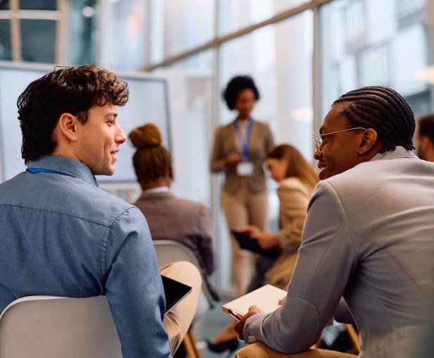 Two people in a conference hall looking at each other